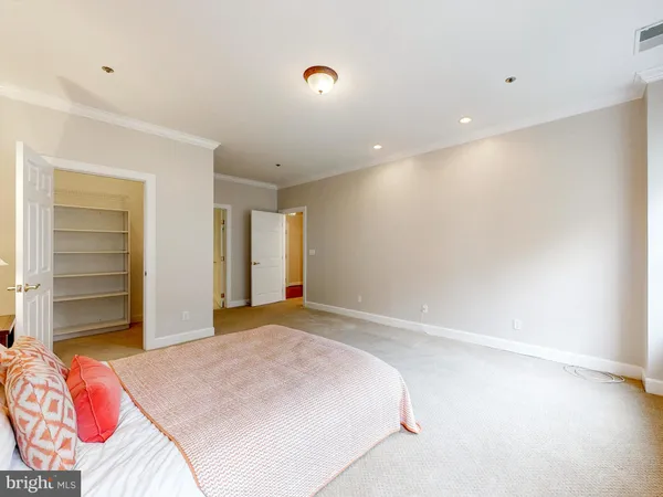 a bedroom with a bed and a walk in closet