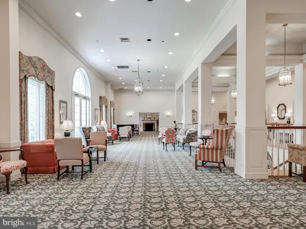 a living room with furniture and a dining table