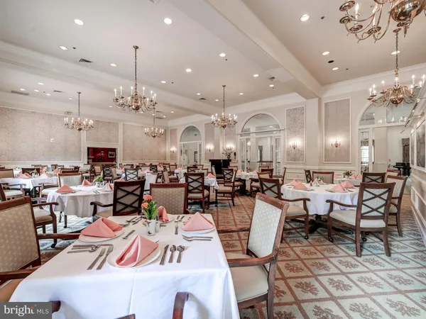 a living room with lots of furniture and view of kitchen