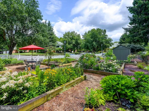 a view of a house with a small yard and wooden fence