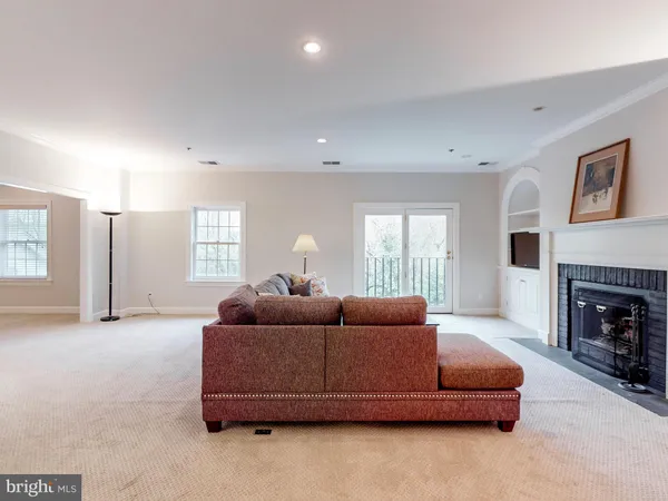 a living room with furniture window and a fireplace