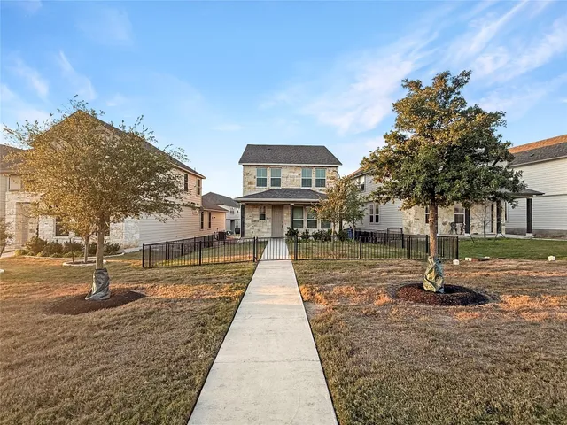 a view of a big house with a big yard