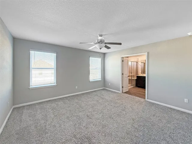 a view of a livingroom with a ceiling fan and window