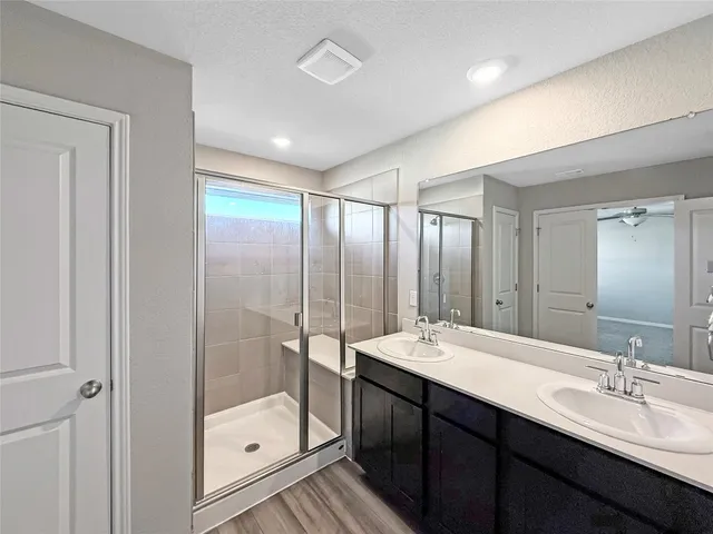 a bathroom with a glass shower door