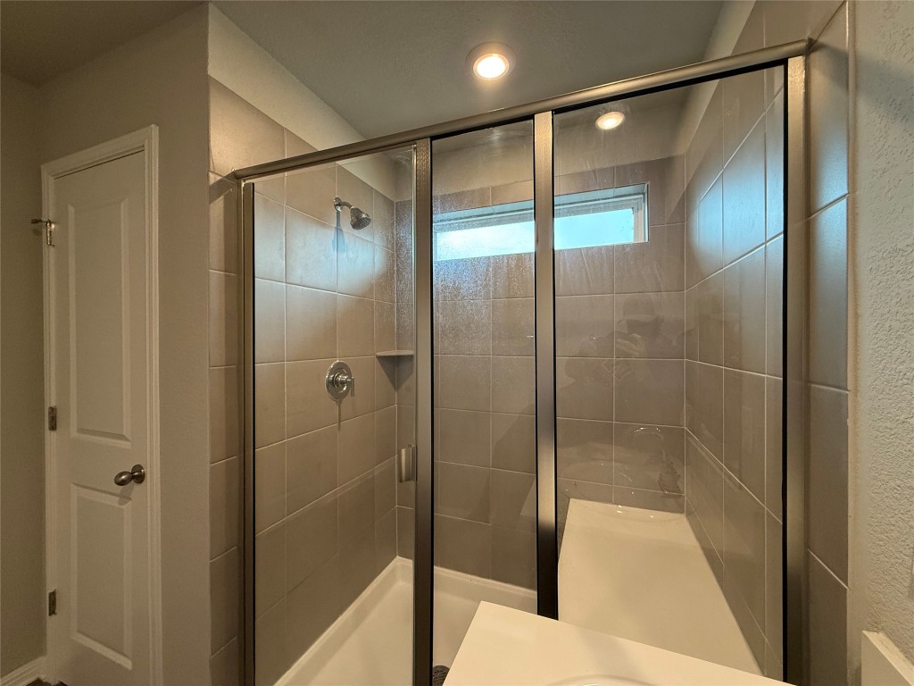 953 Lone Peak Way Dripping Springs, TX 78620 - Photo 17 of 35 Primary Bathroom with a Framed Glass Door
