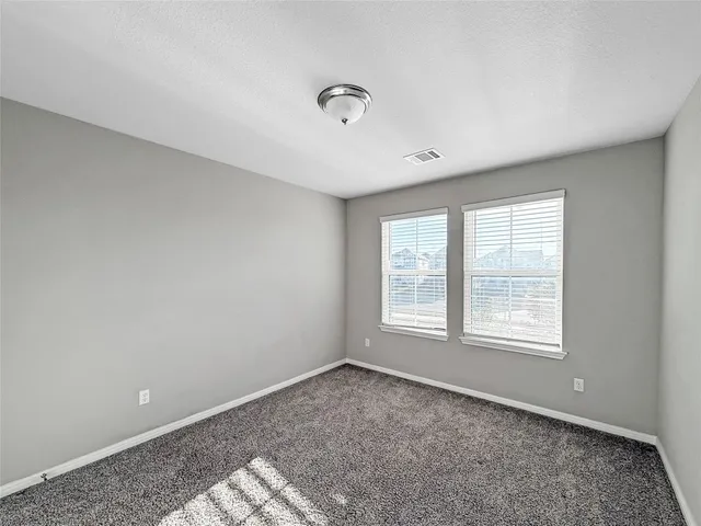 a bedroom with a bed and cabinets