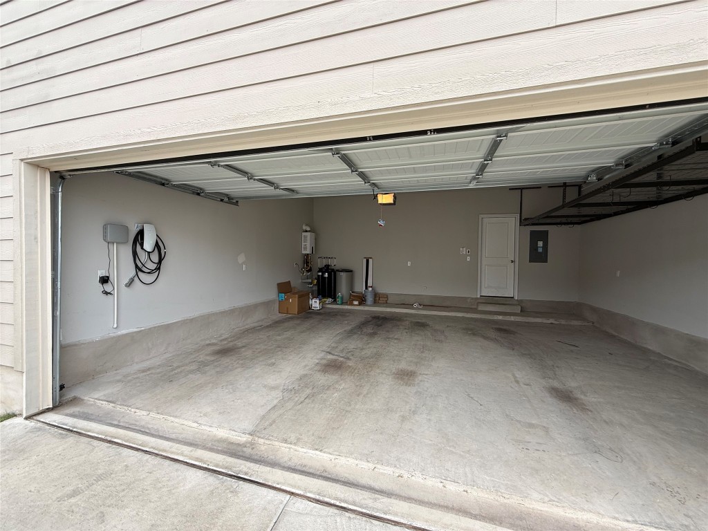 953 Lone Peak Way Dripping Springs, TX 78620 - Photo 29 of 35 Garage With Tesla EV Charger