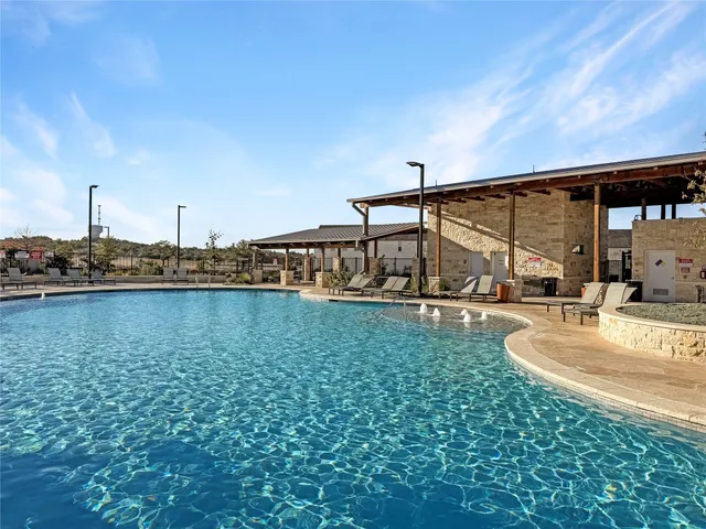 a view of a swimming pool with a yard