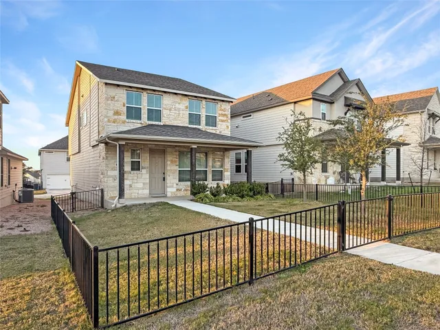 a view of a house with iron fence