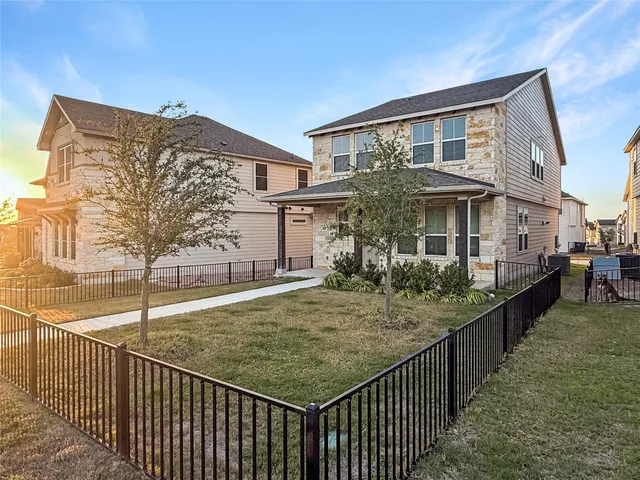a view of kitchen with kitchen island microwave and refrigerator