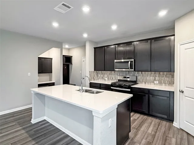 a kitchen with a refrigerator and a sink