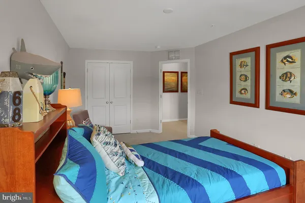 a view of a white house with large windows and a yard