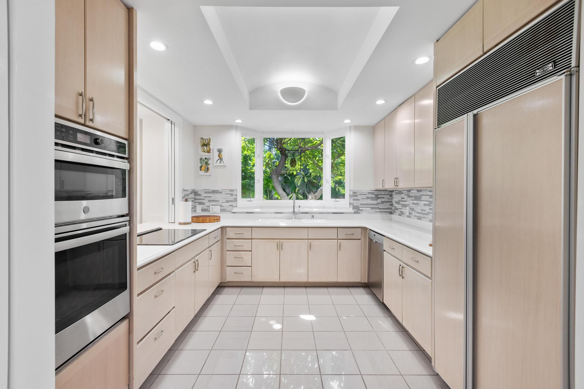 68-1375 Pauoa Road, Unit M4 Kamuela, HI 96743 - Photo 12 of 30 a large white kitchen with stainless steel appliances granite countertop a large stove top oven and a refrigerator