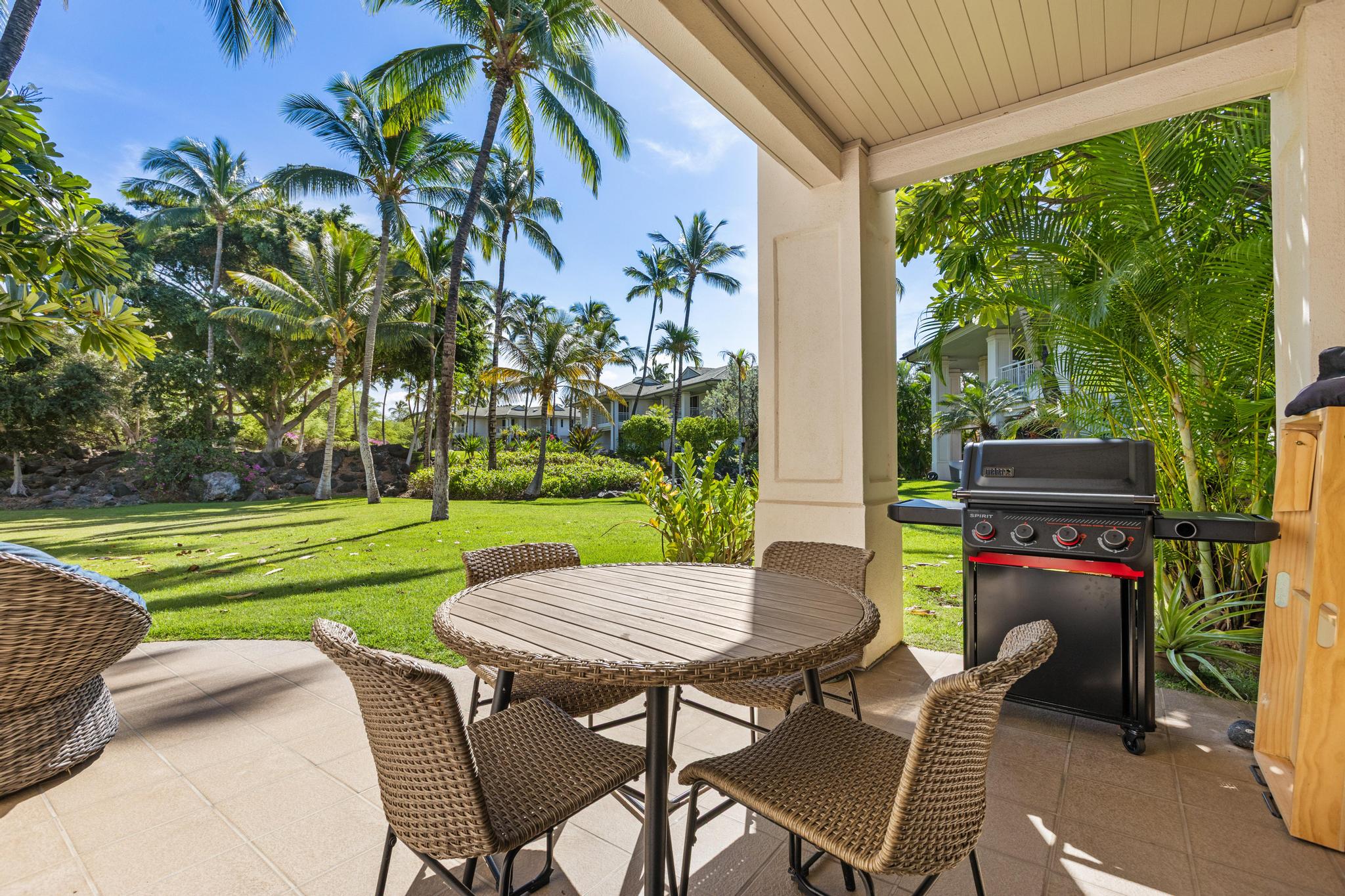 68-1375 Pauoa Road, Unit M4 Kamuela, HI 96743 - Photo 6 of 30 a view of a patio with table and chairs potted plants and palm trees