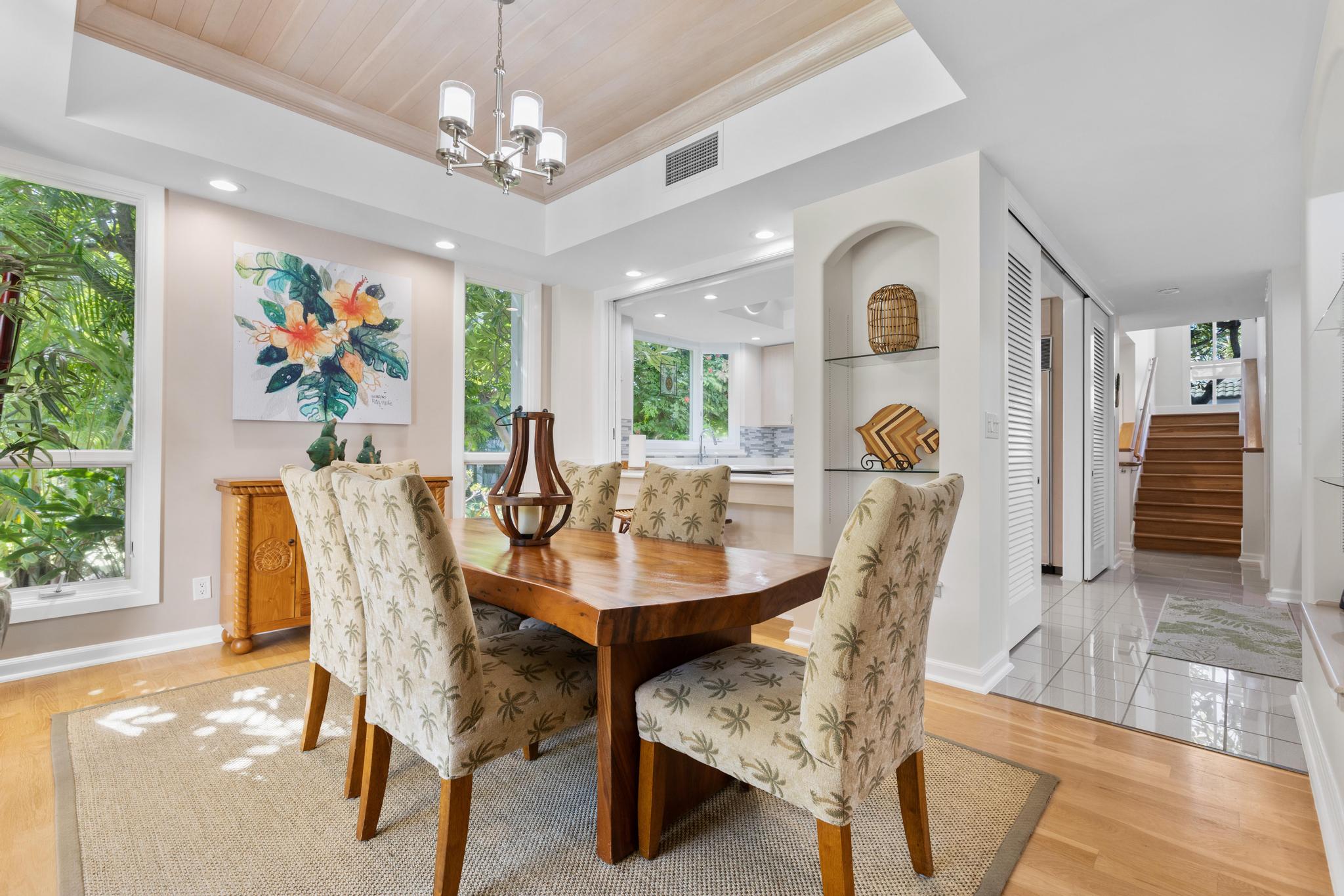 68-1375 Pauoa Road, Unit M4 Kamuela, HI 96743 - Photo 10 of 30 a view of a dining room with furniture wooden floor and chandelier
