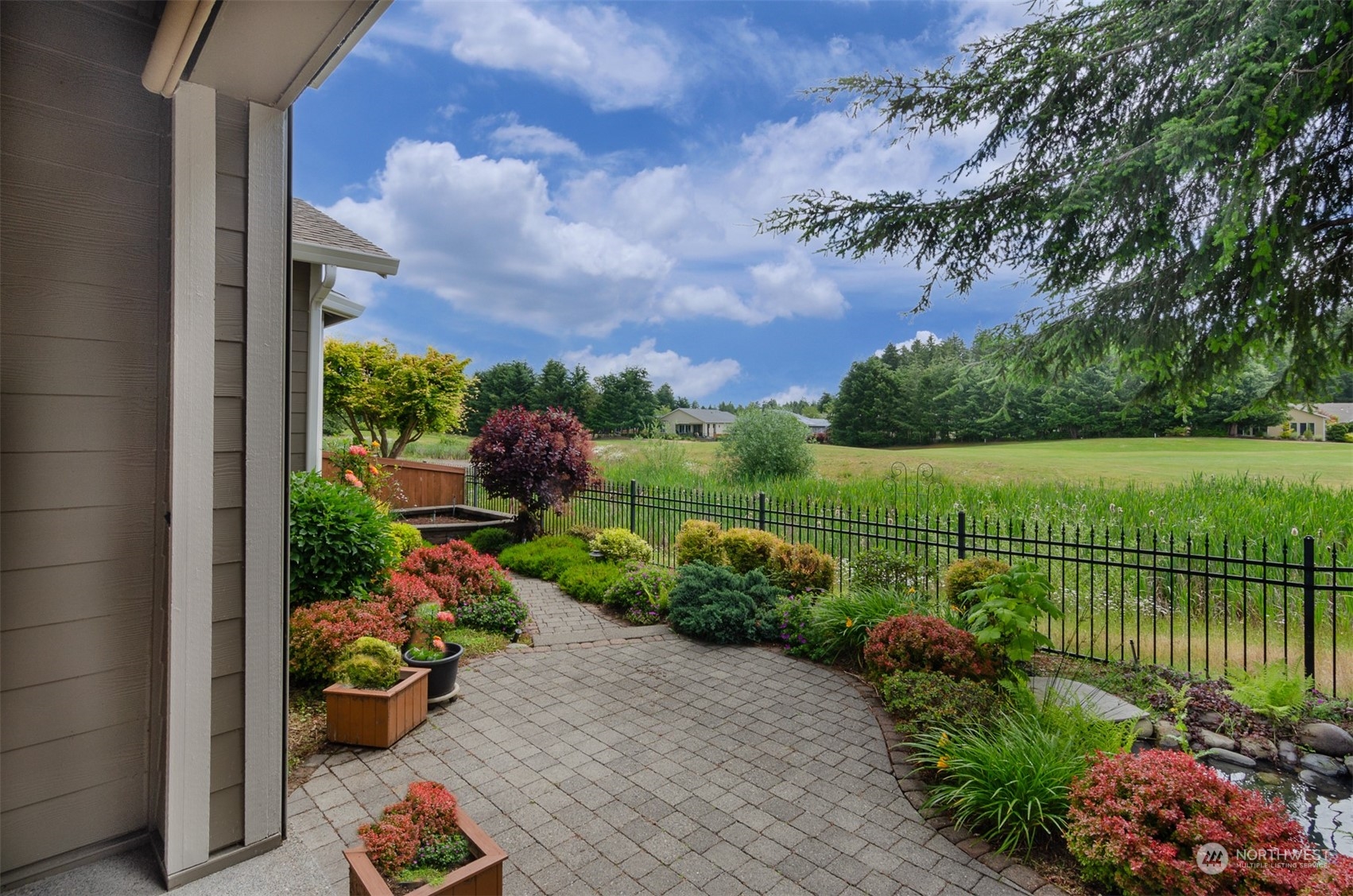 8401 Orcas Loop Northeast Lacey, WA 98516 - Photo 11 of 40 a view of a garden with a bench in front of house