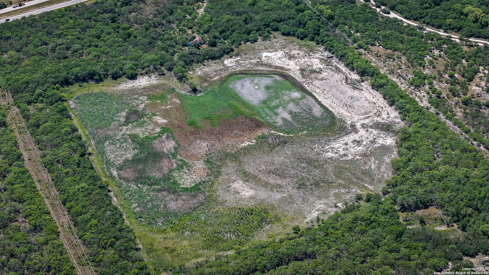 6266 Highway 281 Three Rivers, TX 78071 - Photo 9 of 37 an aerial view of a house with a yard and trees all around