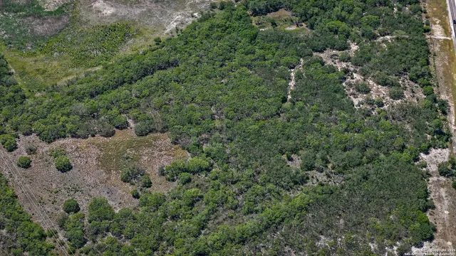 an aerial view of a houses with a yard