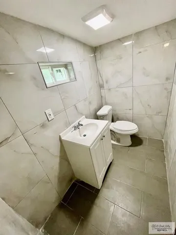 a view of a big room with wooden floor closet and chandelier fan