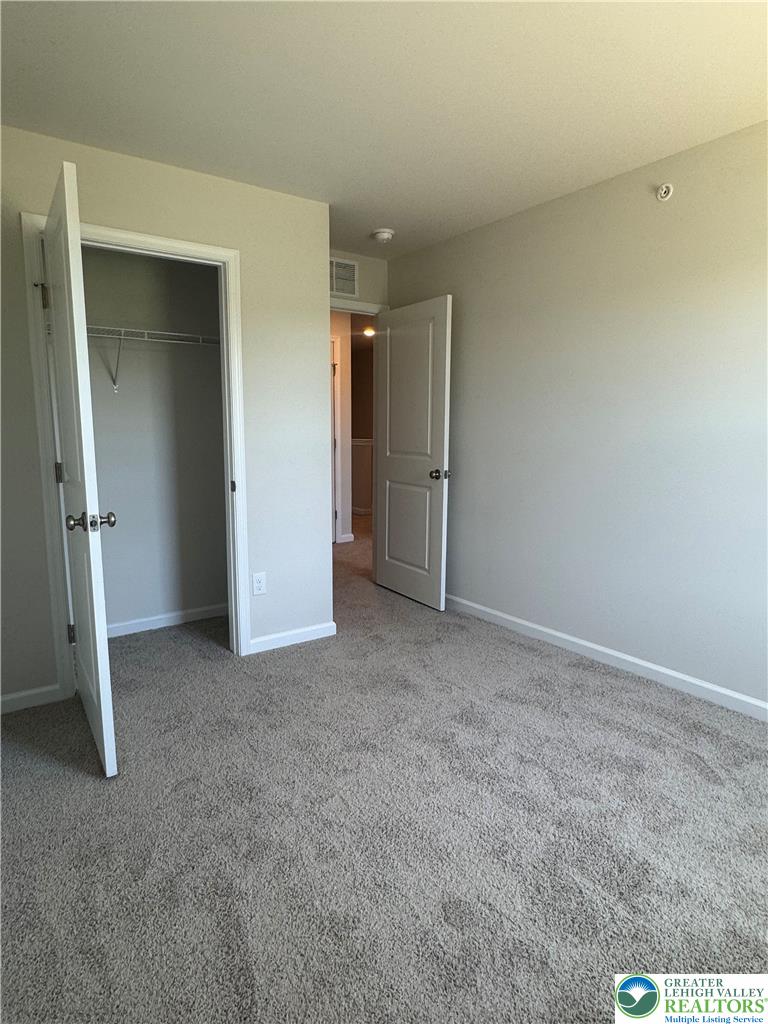 1168 Martin Road Breinigsville, PA 18031 - Photo 6 of 11 A well-lit bedroom features plush carpeting and convenient closet space.