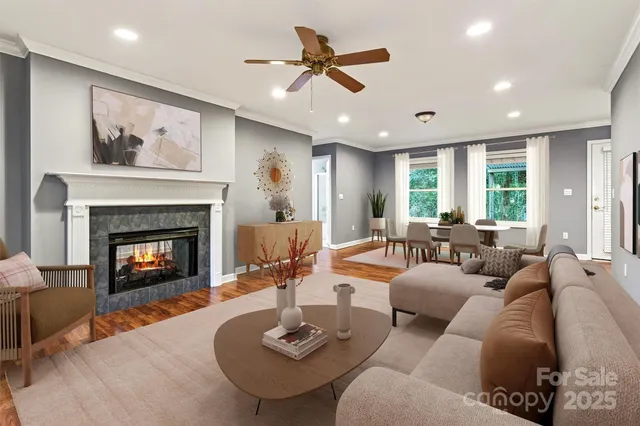 an empty room with wooden floor and a ceiling fan