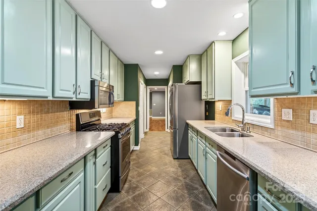 a view of an empty room with a window and a ceiling fan