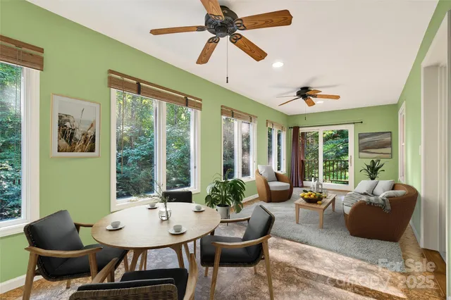 an empty room with a window and a ceiling fan