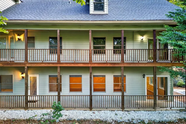 a front view of house with yard and trees in the background