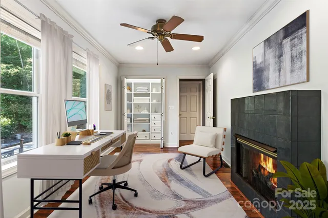 a view of an empty room with a window and a ceiling fan