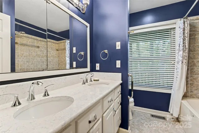 a view of an empty room with a window and cabinet