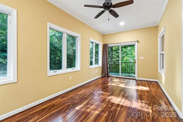 an empty room with closet and windows