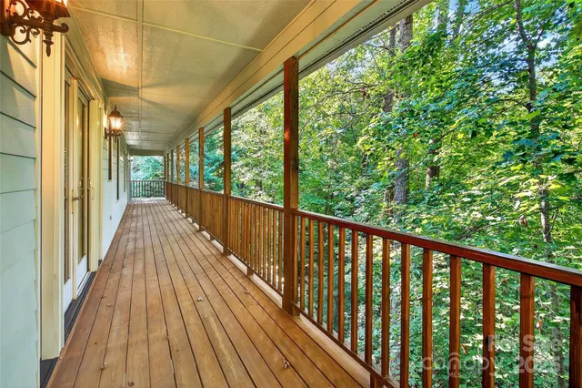 a view of backyard with a deck and wooden floor