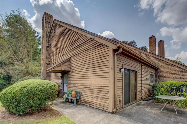 a view of a chair and table in the house