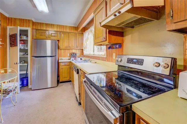 a kitchen with a stove and a refrigerator