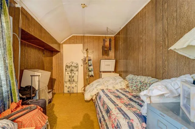 a bed sitting in a bedroom next to a window