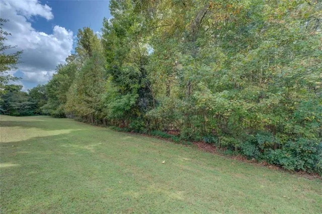 a view of a big yard with lots of green space and deers