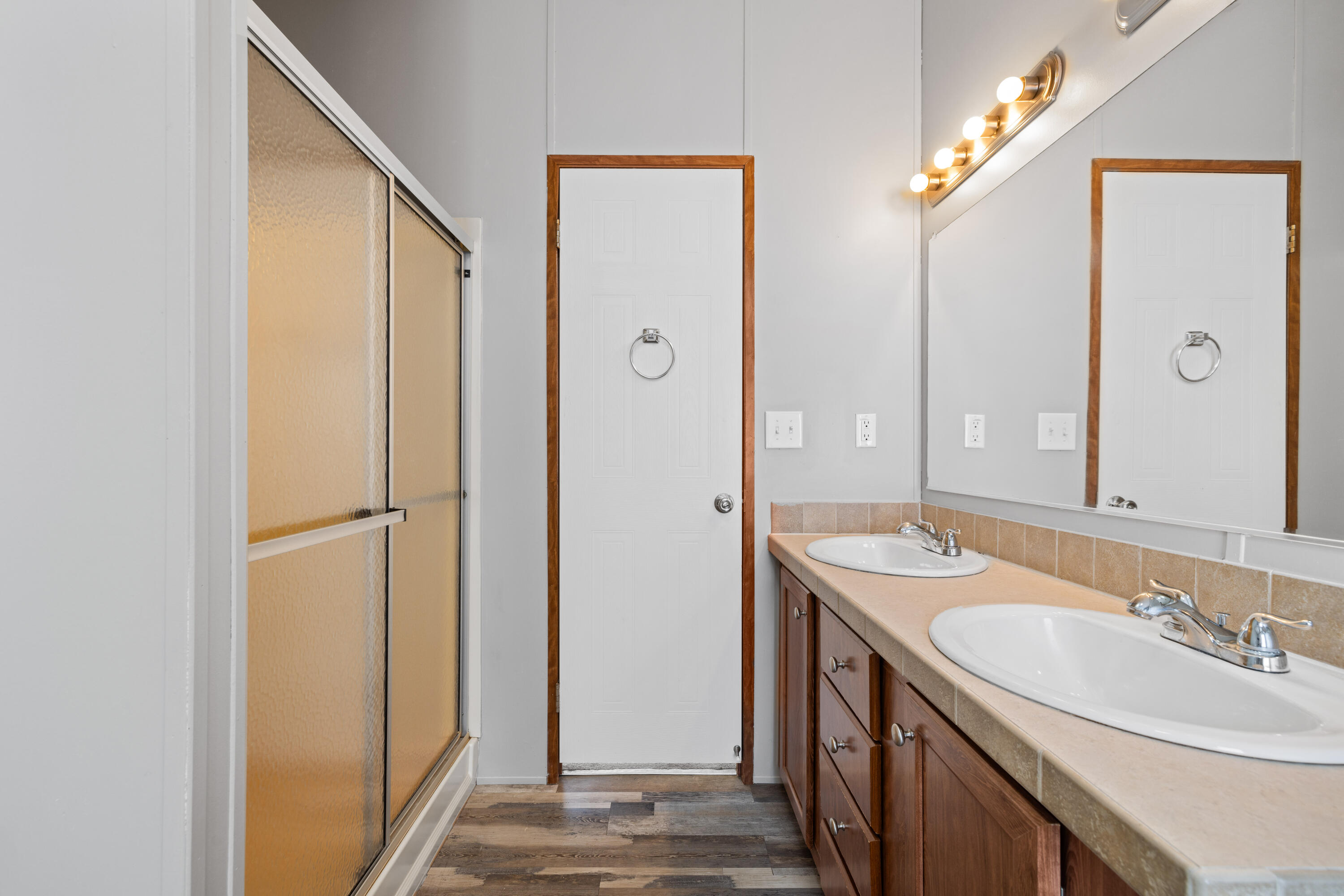7140 Southeast Ridgeway Terrace Hobe Sound, FL 33455 - Photo 12 of 17 Master bathroom, sink, and shower