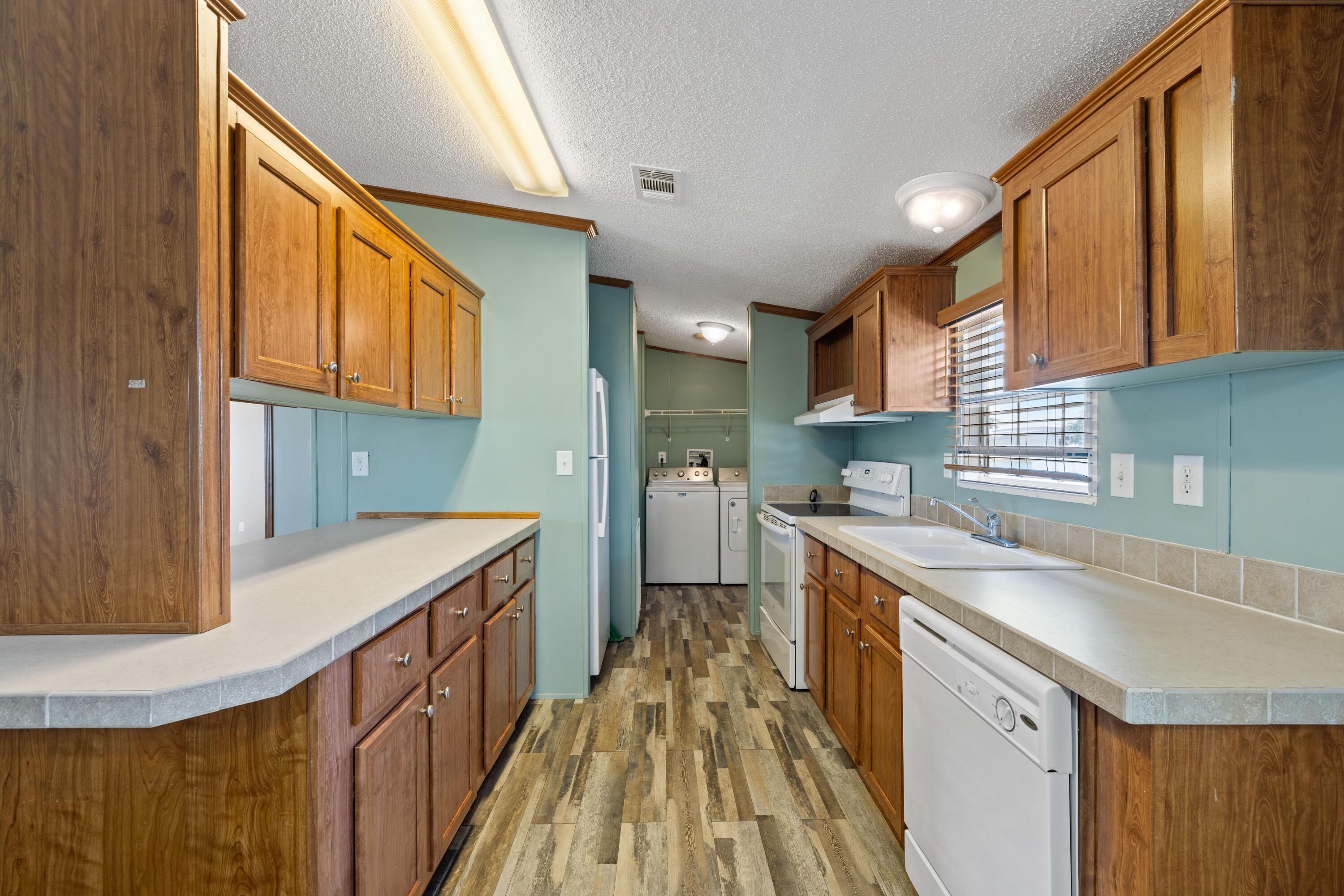 7140 Southeast Ridgeway Terrace Hobe Sound, FL 33455 - Photo 4 of 17 Kitchen with laundry room