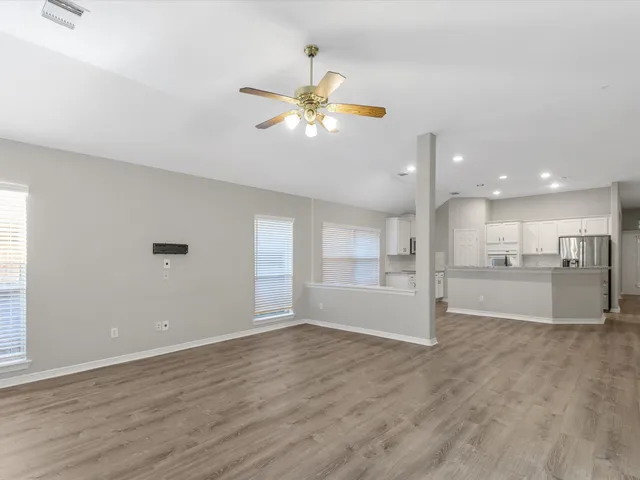 a view of kitchen with refrigerator and window