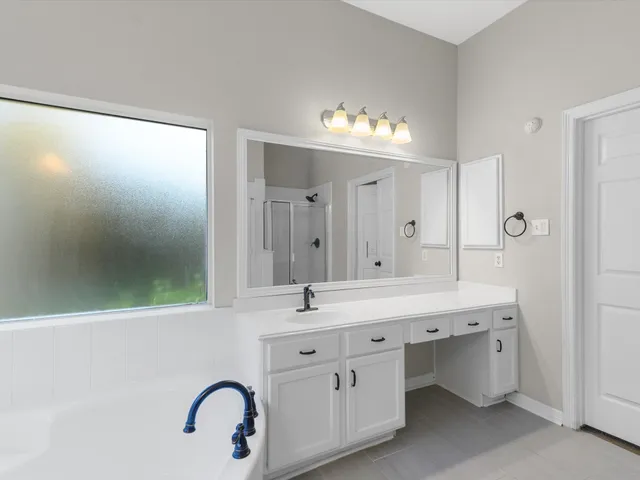 a bathroom with a double vanity sink and a mirror