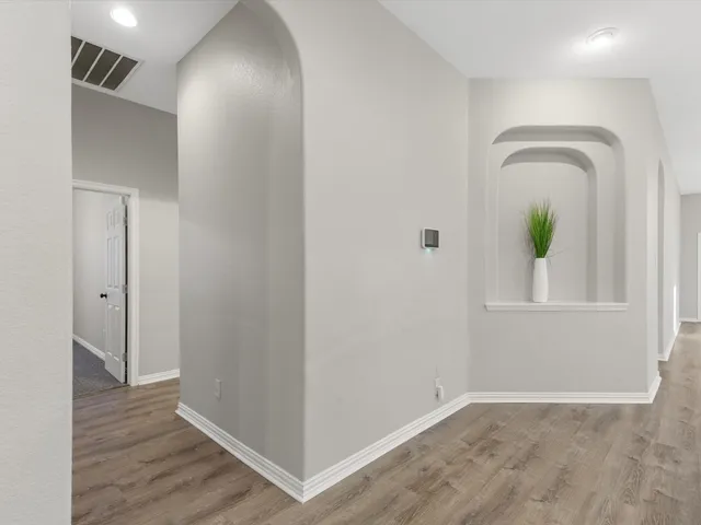 a view of an entryway with wooden floor