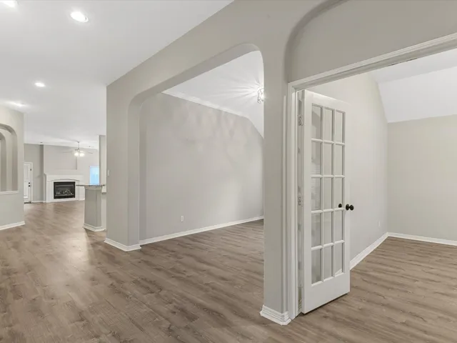 a view of a hallway with wooden floor