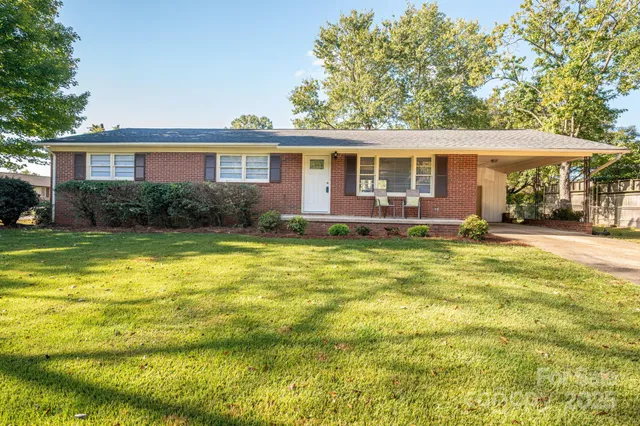 a front view of a house with a yard table and chairs