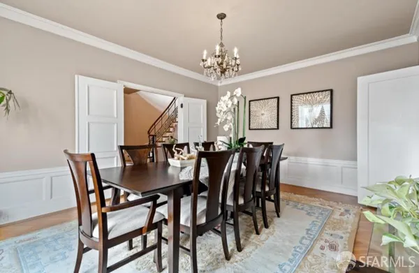 a view of a dining room with furniture and chandelier