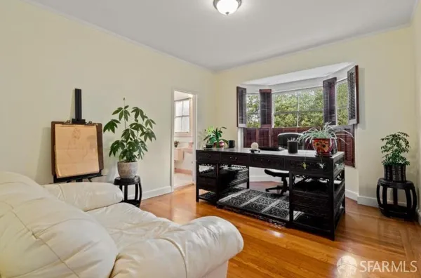 a bedroom with furniture and a potted plant