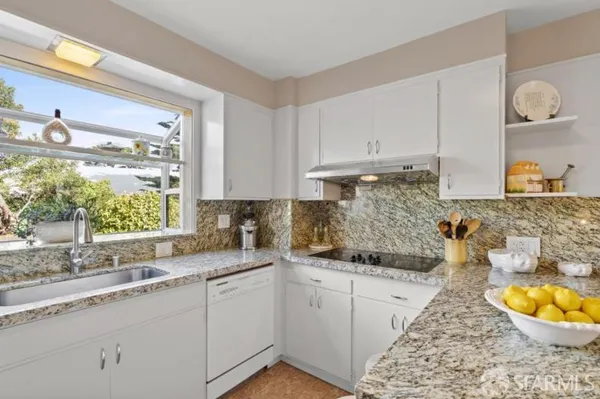 a kitchen with a sink and cabinets