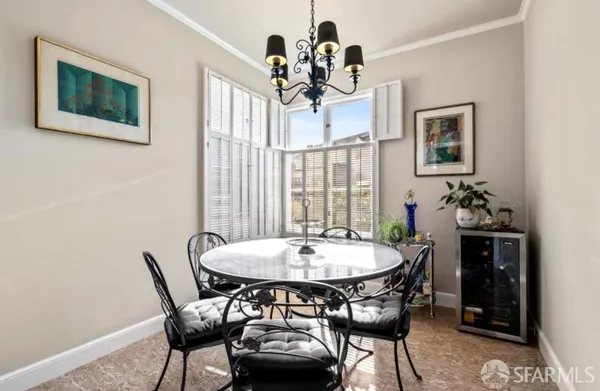 a view of a dining room with furniture and chandelier