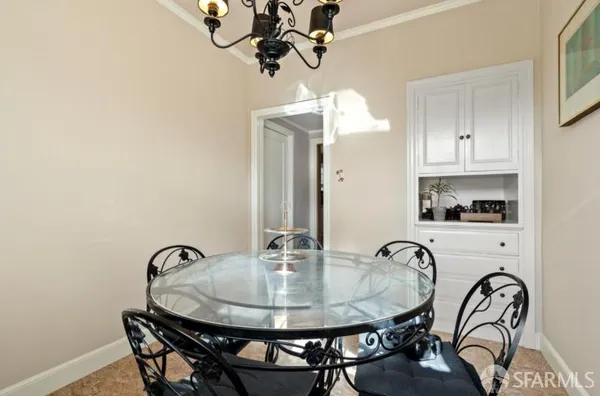a dining room with table chairs and chandelier