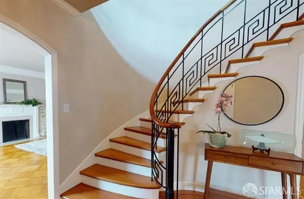 a view of entryway and hall with wooden floor