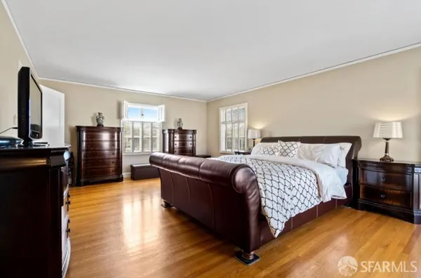 a bedroom with a bed cabinets and a dresser